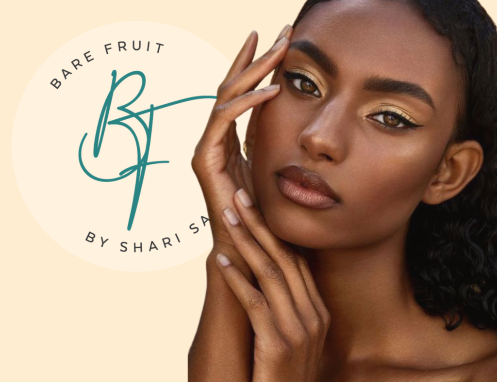 Beautiful black woman with a perfect brow poses next to the BareFruit by Shari Saint brows and lashes services photo