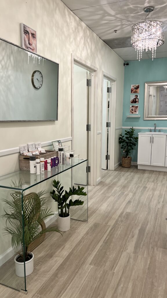 Bare Fruit Sugaring & Brows Westbury Location Hallways with tables sink, plants and blue walls